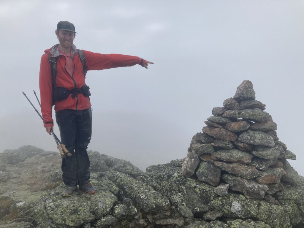 Hiker on top of a NH 48 in the rain