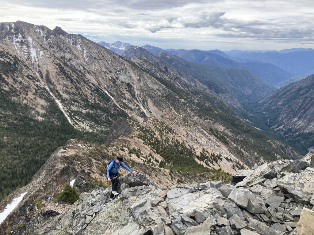 Carolyn scrambling the ridgeline up Monument Peak in the Pasayten Wilderness