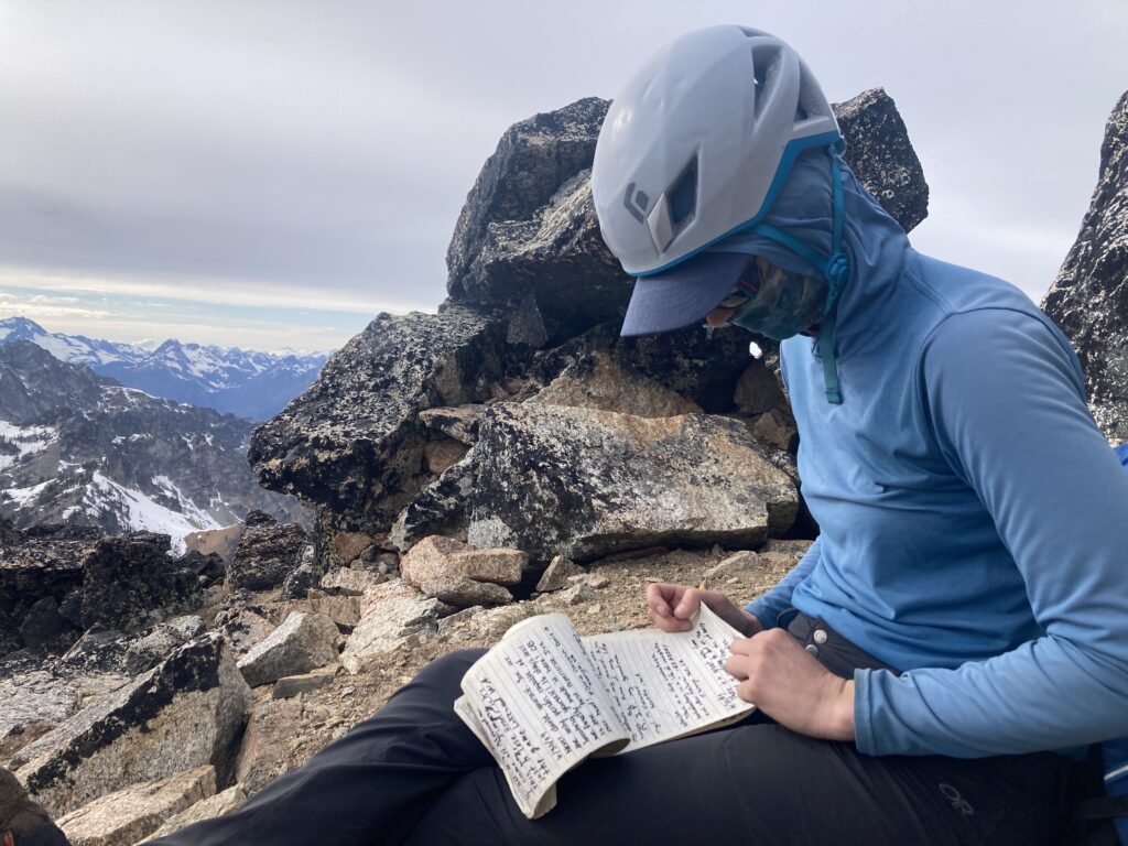 Carolyn signs the summit register on top of Emerald Peak in the Entiat Wilderness