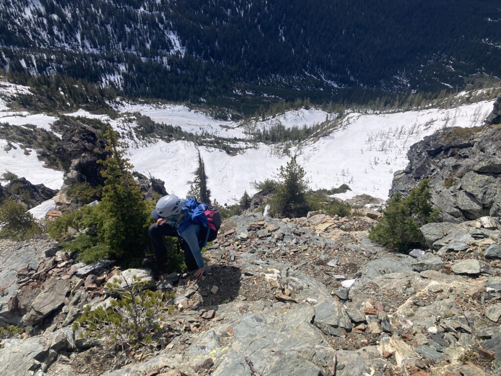 Hiker hiking up steep loose rock on Saska Peak in the Cascades