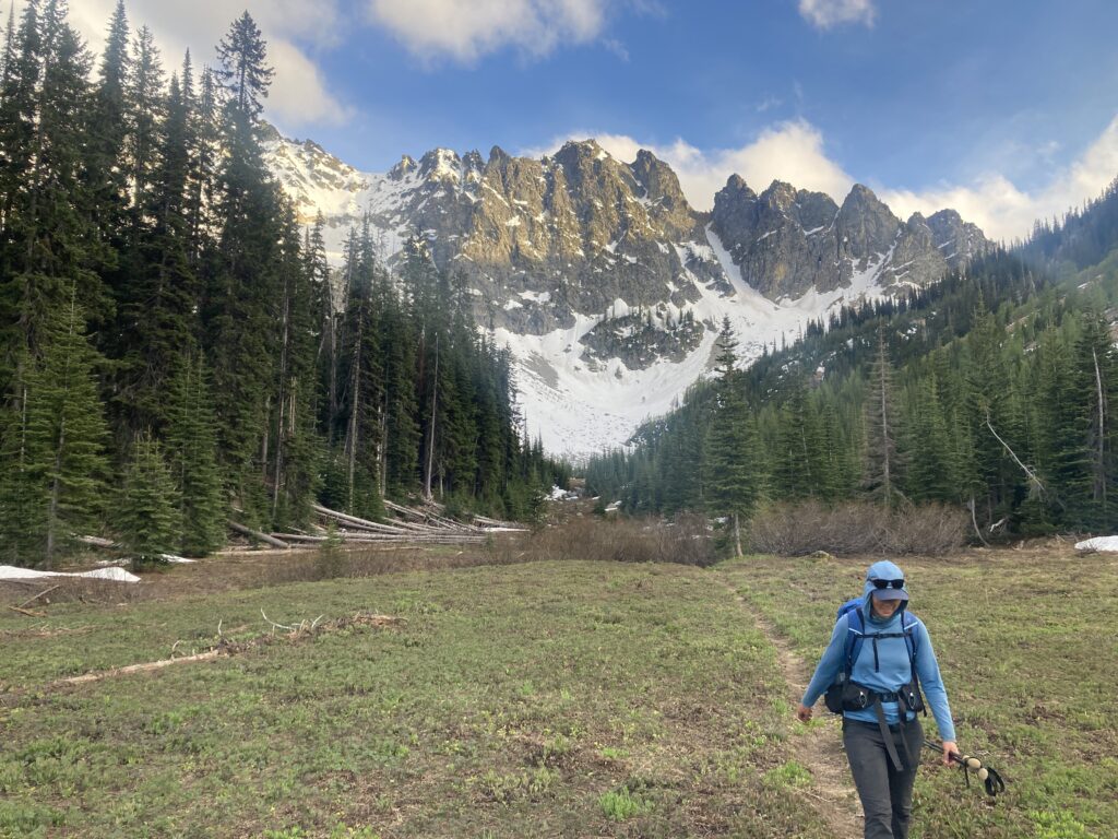 Evening light illuminates Emerald Peak as Carolyn hikes through Emerald Park in the Entiat Wilderness.