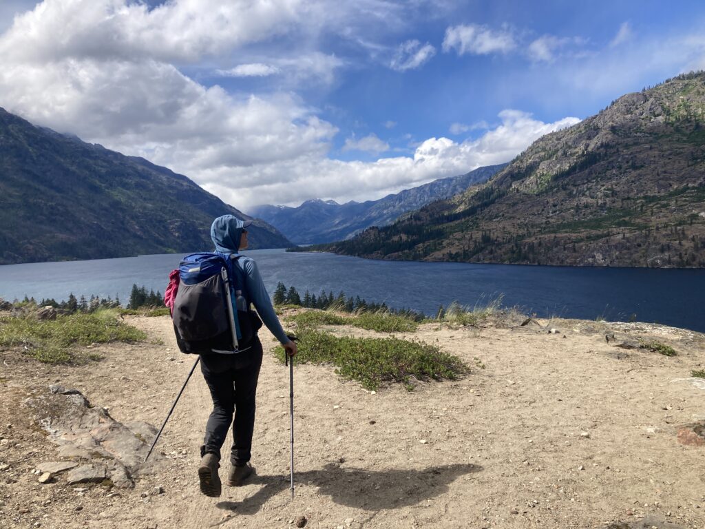 Carolyn hiking past a lookout over Lake Chelan, Cascades, Washington State