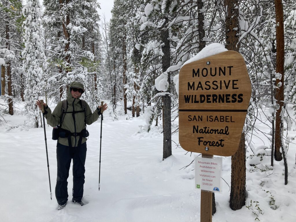 Carolyn stands next to Mount Massive Wilderness trail sign on the Colorado Trail