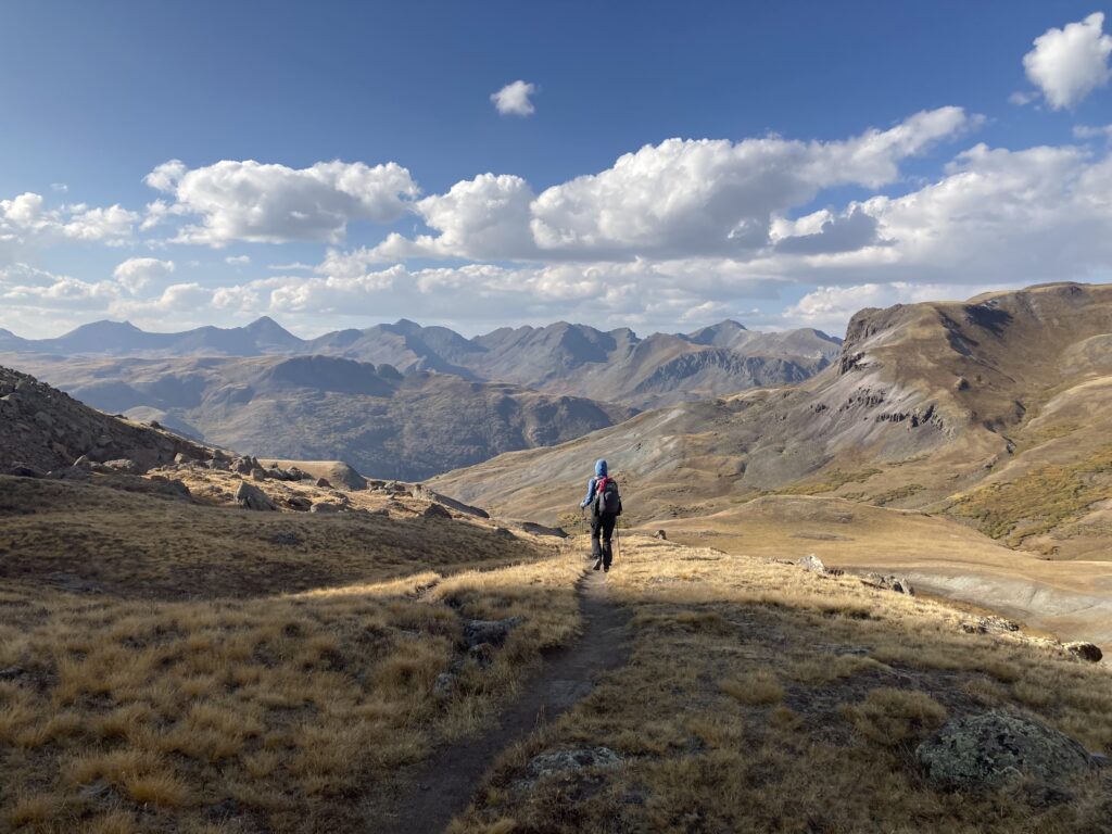 Sweeping mountain views in front of Carolyn as she walks in the San Juans section of the Colorado Trail