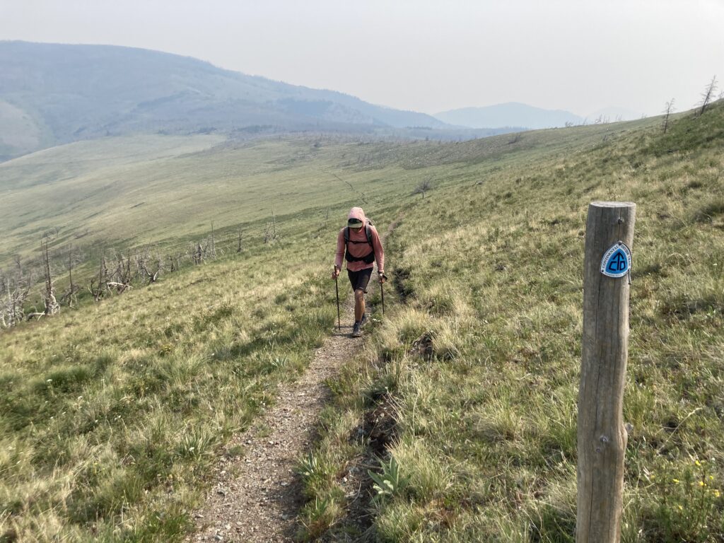 Jeff hking past a Contiental Divide Trail sign heading though Montana