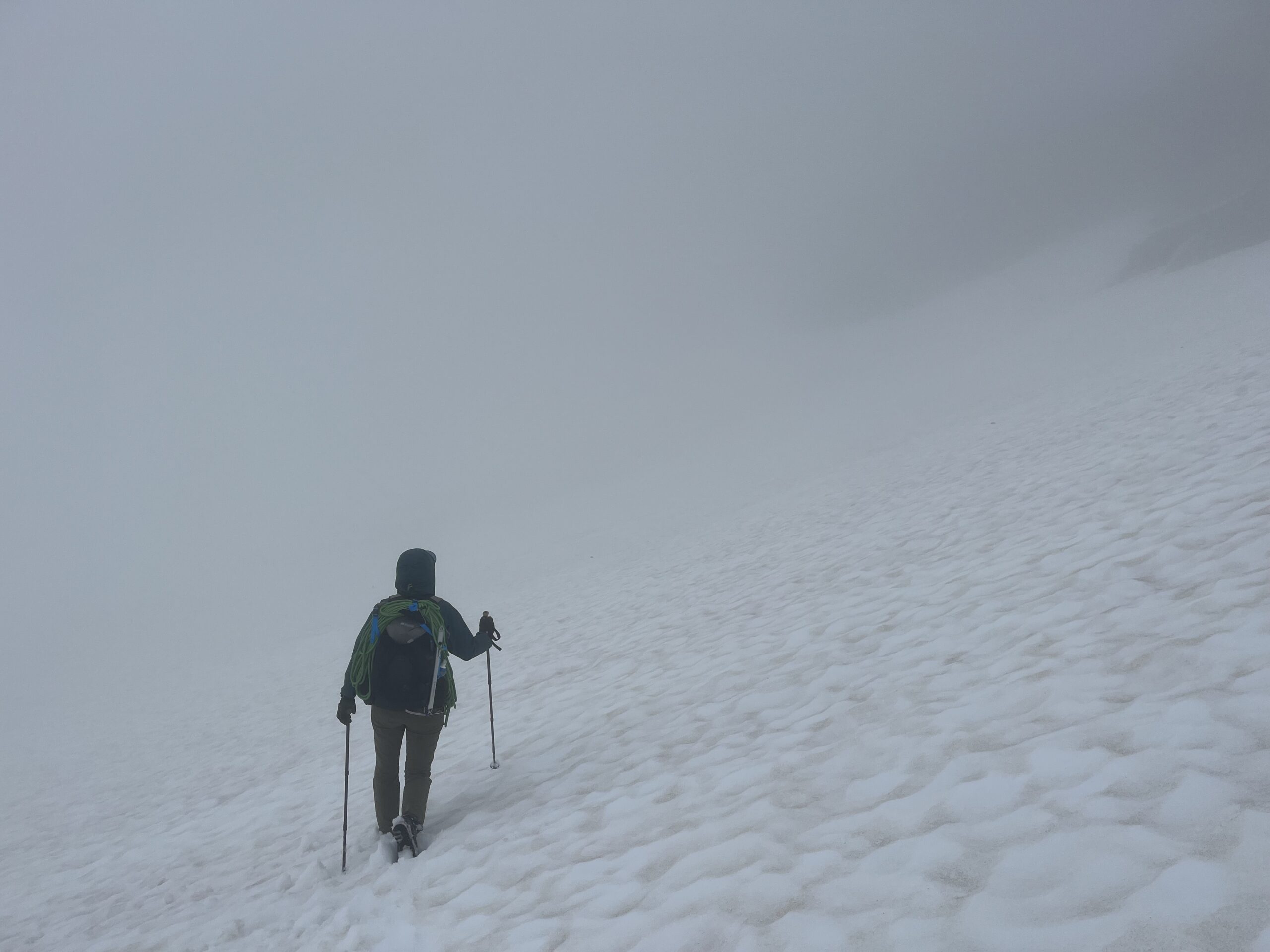 Carolyn hiking in a white out on the White Chuck Glacier in the Glacier Peak Wilderness of the Cascades
