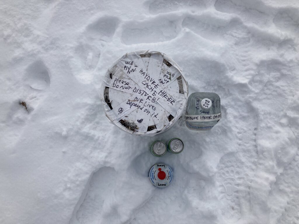 A labled food cache bucket along the Hayduke Trail