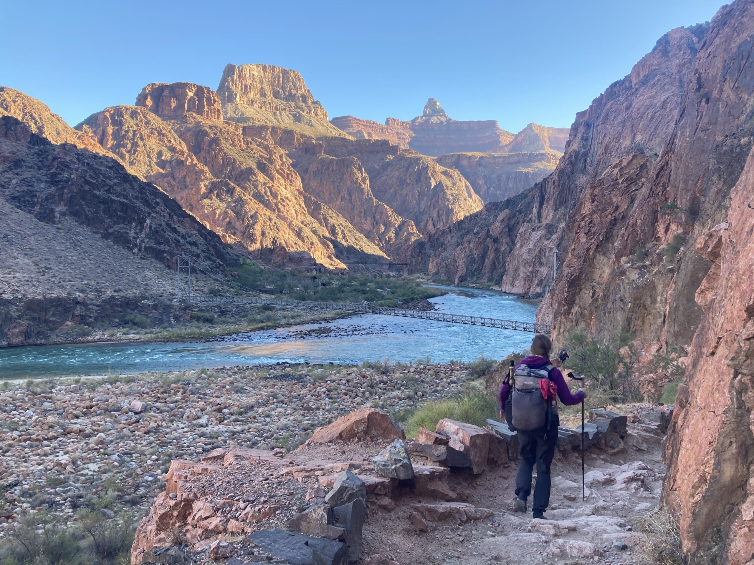 Carolyn walking along the Colorado River at the bottom of the Grand Canyon