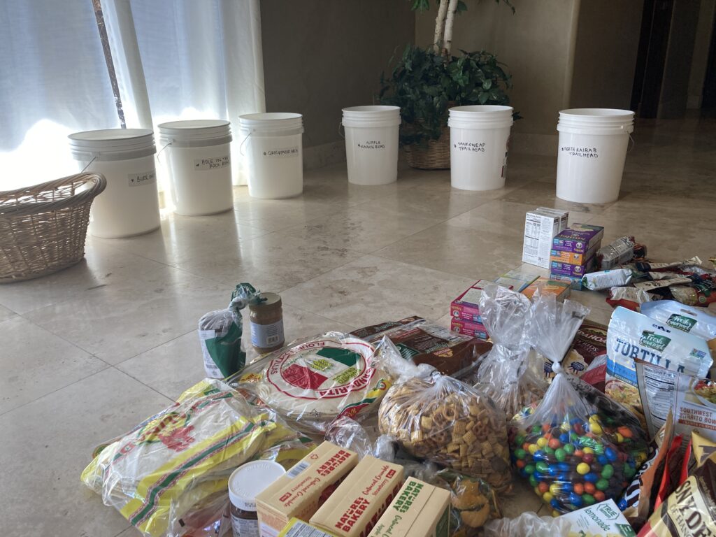 Hikers prepare buckets of food for caches along the hayduke trail
