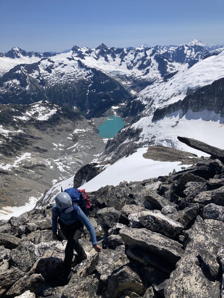 Carolyn scrambling up Primus Peak in the North Cascades in Washington