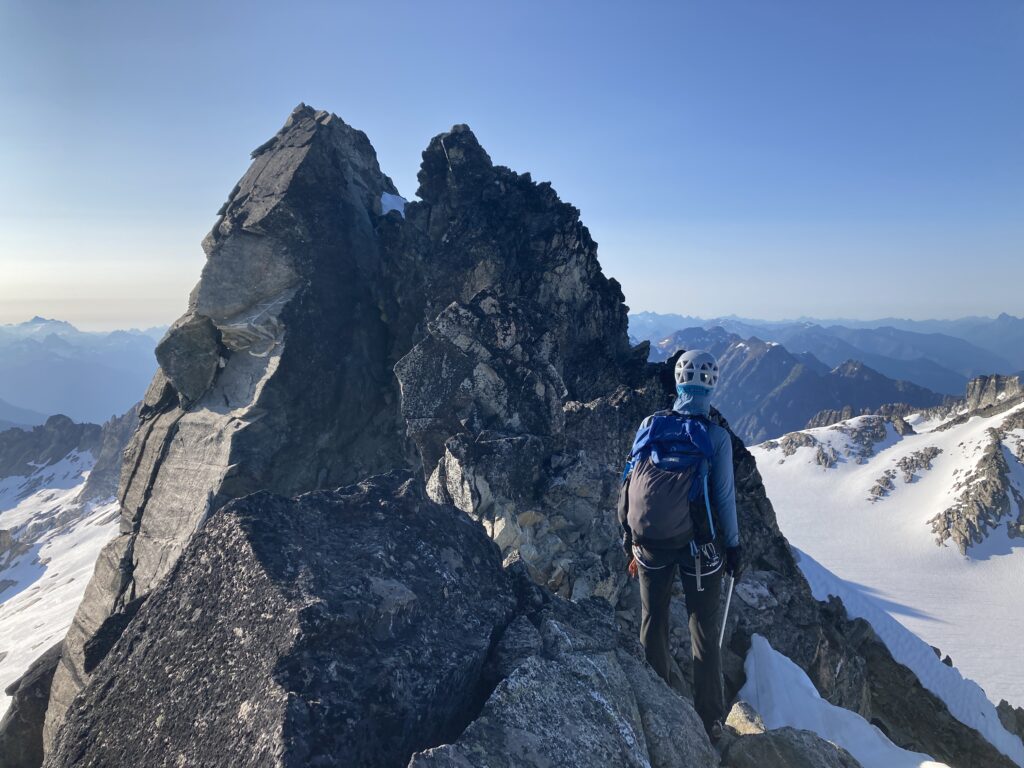 Carolyn looking at the final summit block of Austera Peak