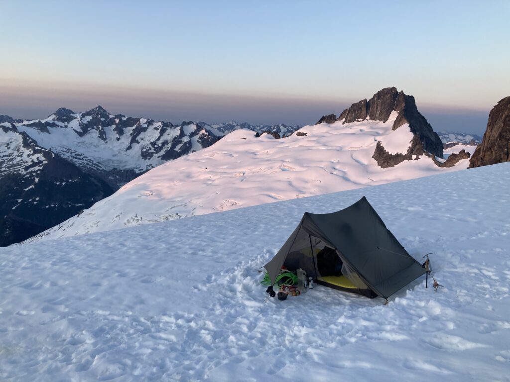 Beautiful sunrise over a campsite in the North Cascades along the Inspiration Traverse