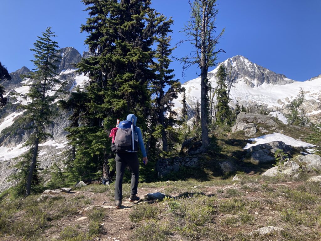 Carolyn hiking with Primus Peak and Primus Glacier in the distance in North Cascades National Park