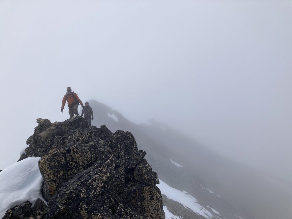 Climbers scramble the third class ridgeline on Robinson Mountain in the Pasayten Wilderness