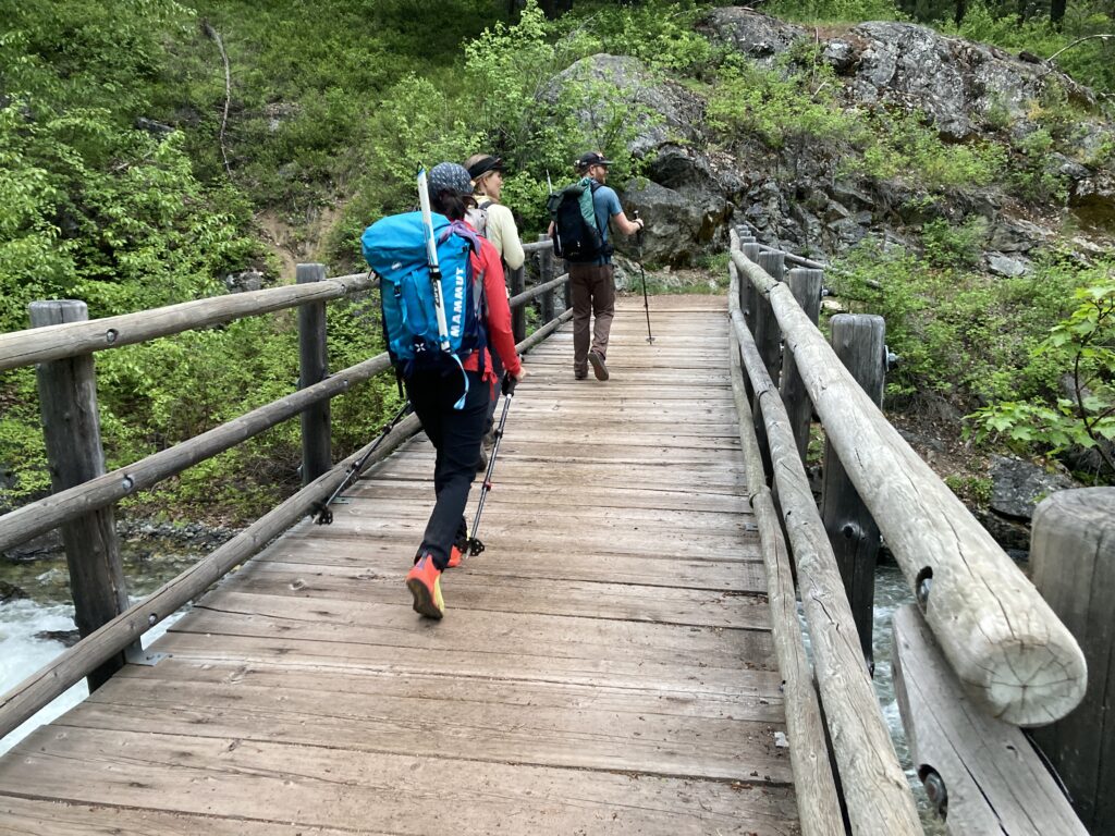 Hikes walking across the birdge over Robinson Creek in the Pasayten Wilderness towards Robinson Mountain