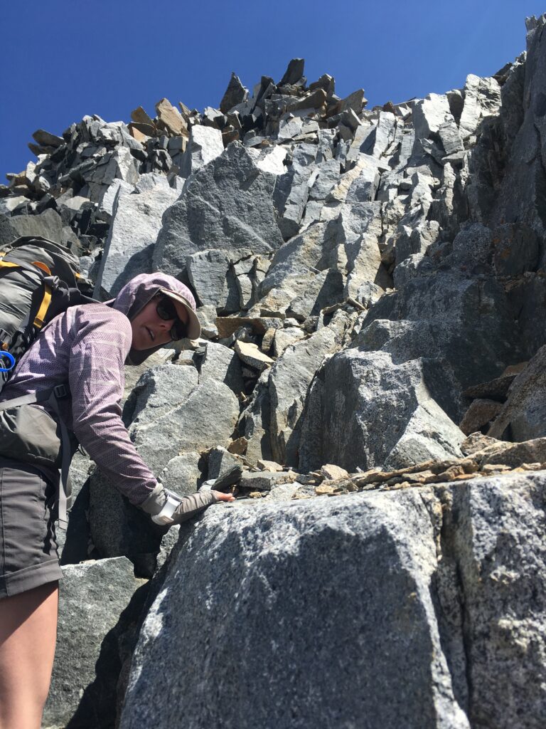 Scrambling over loose alpine rock near the summit of Mount Baxter