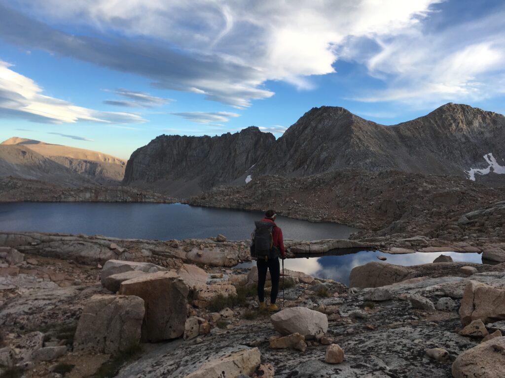 Carolyn hiking through Miter Basin surrounded by granite peaks