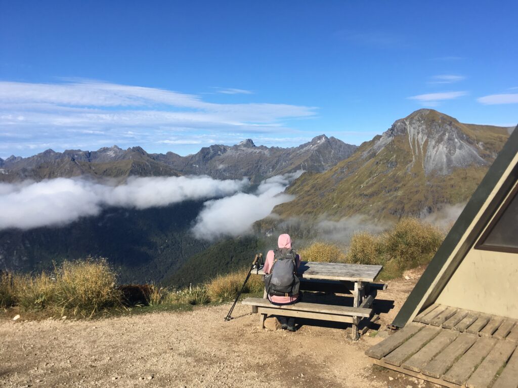 Jeff taking a break on the Kepler Track looking at swirling clouds on the Te Araroa alternate