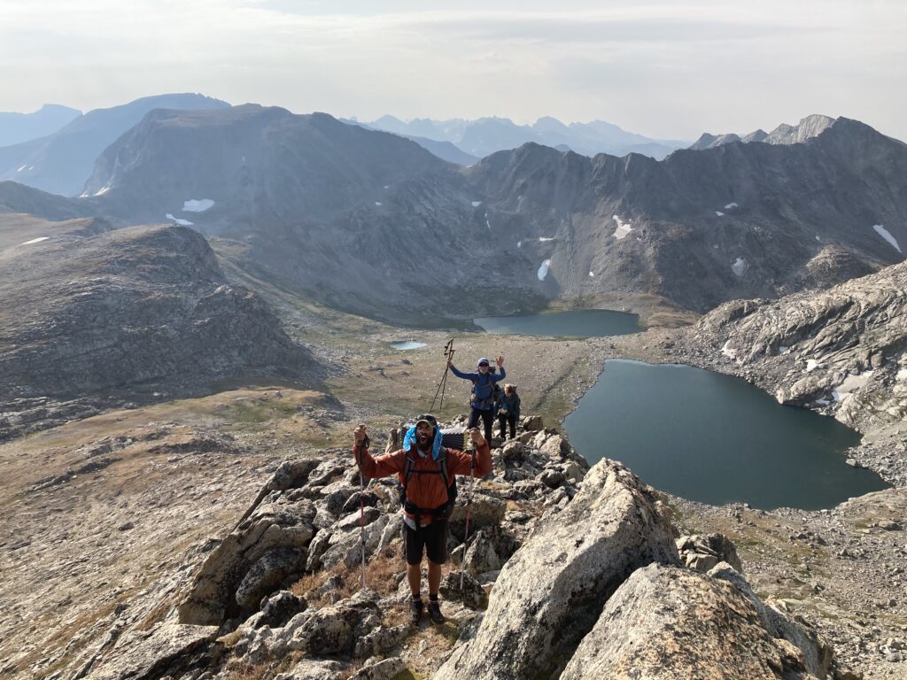 Backpackers scrambling up Europe Peak on the Wind River High Route