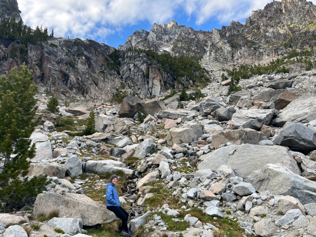 Carolyn relaxes by an alpine creek below Sherpa Peak in the Alpine Lakes Wilderness in Washington State
