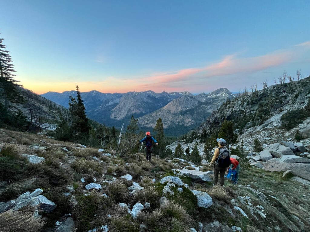 Sunrise with hikers climbing Sherpa Peak in the Alpine Lakes Wilderness