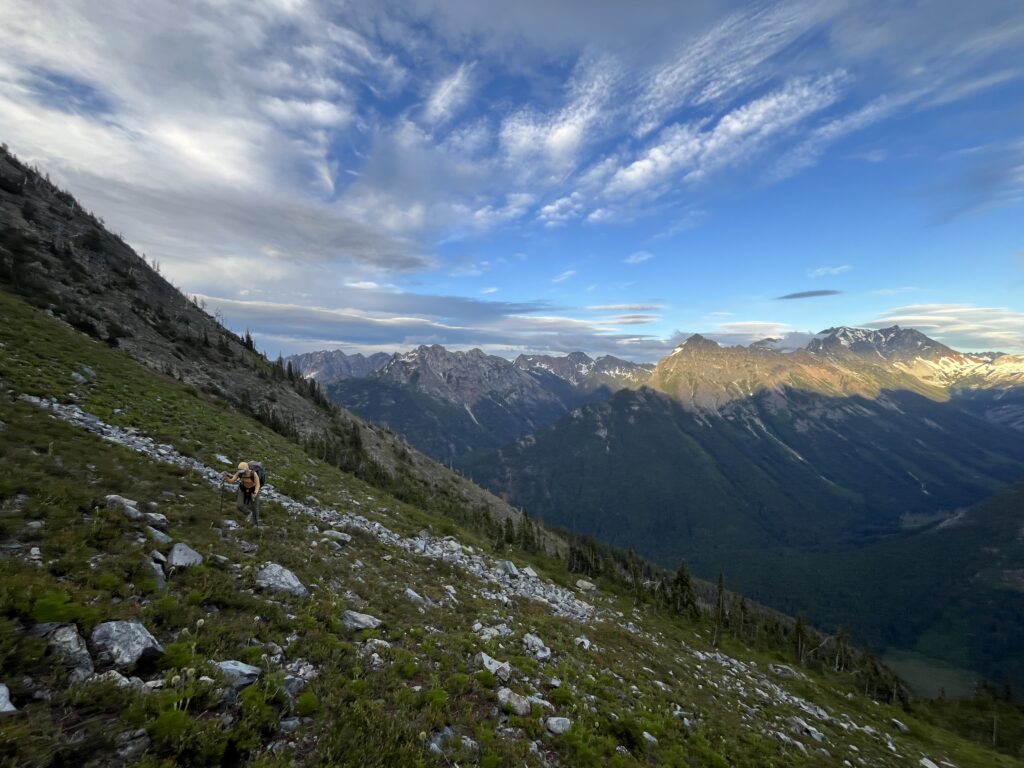 Carolyn hiking with beautiful sunset on Cascades in Glacier Peak Wilderness