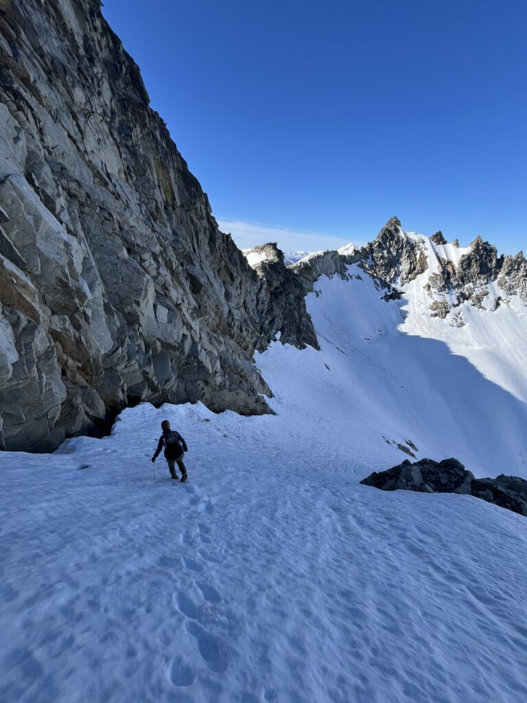 Carolyn stepping onto the Chikamin Glacier from Gunsight Notch in the Glacier Peak Wilderness