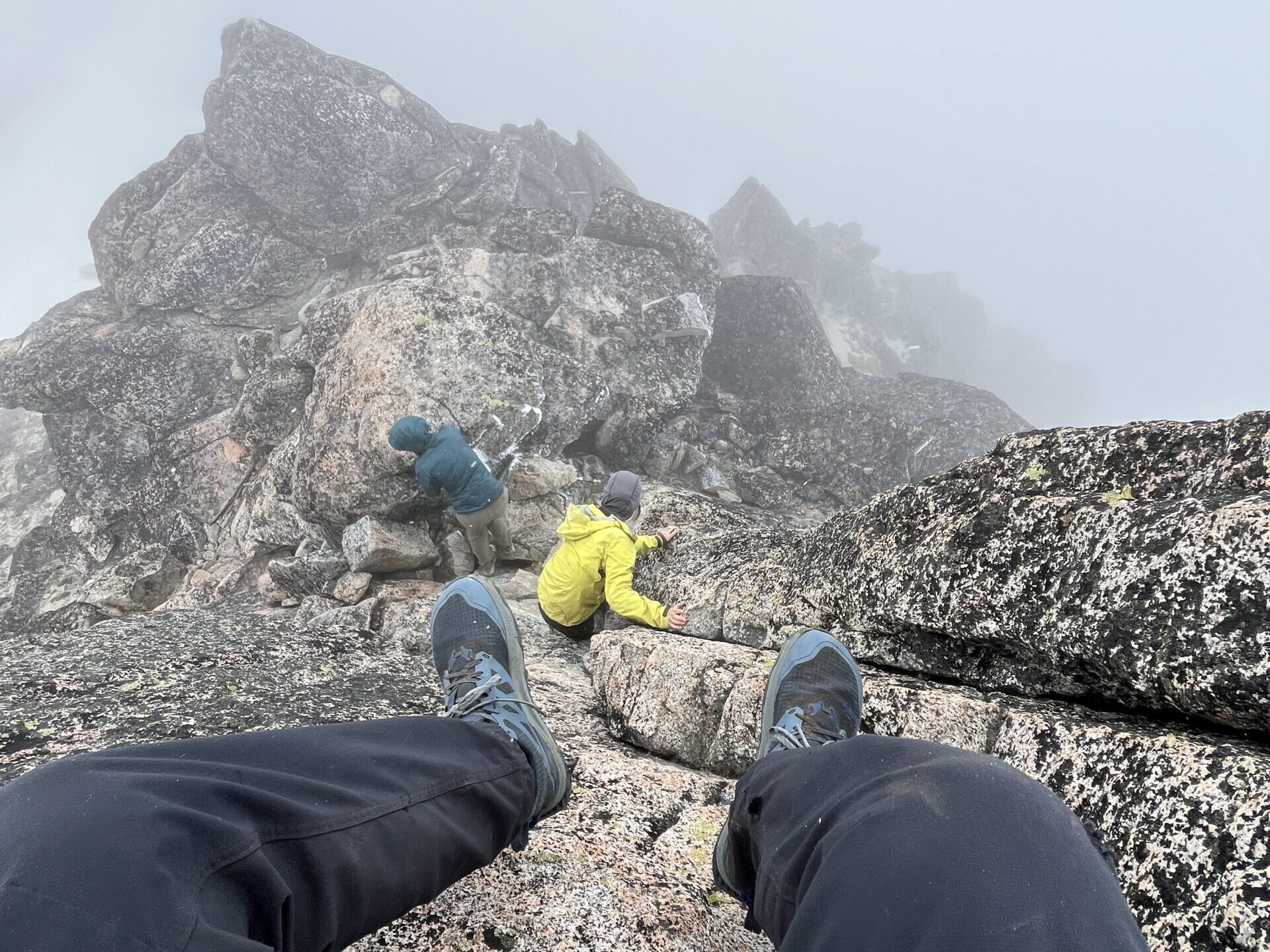 Climbers scrambling the last few feet of Enchantment Peak in the Enchantments area of the Cascades