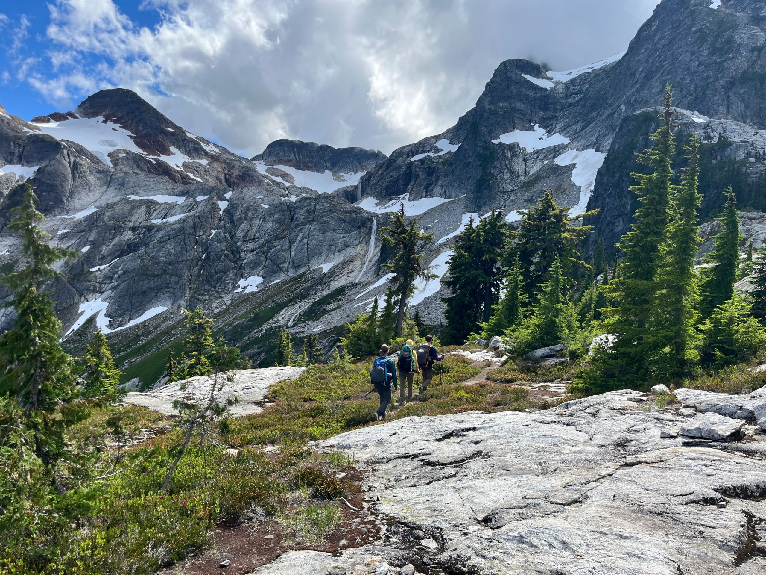 View of Colonial Peak with hikers on the climbers approach trail in the North Cascades of Washington State