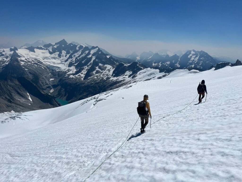 Hikers overlook Inspiration Glacier from the Isolation Traverse in Washington State's North Cascades.