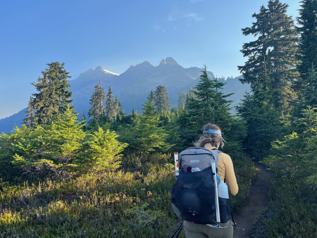 Carolyn hiking in the tree covered trail towards Mt. Shuksan