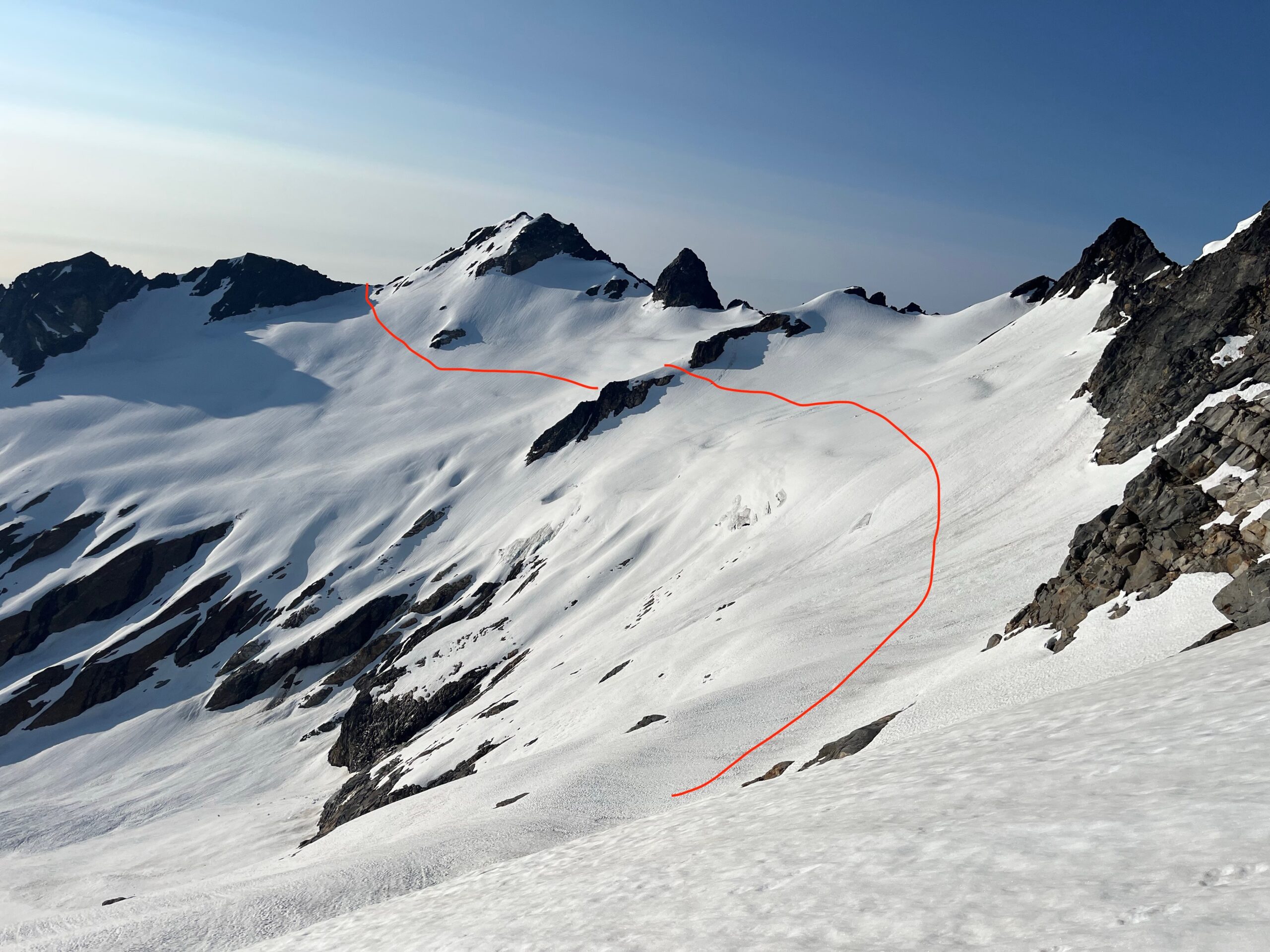 Glacier covered mountains in the North Cascades with a line marking a route through