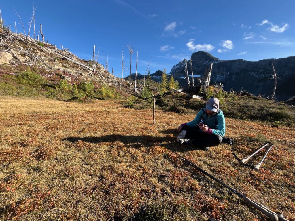 Carolyn taking a break in the sun before setting up camp at Jerry Lakes in the North Cascades of Washington State